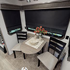Dine in comfort with a full view of your campsite.  Each Champagne Edition unit comes with a dining table with leaf extension and 4 freestanding chairs (2 solid, 2 folding).  The serving credenza houses the outside 32' television. May Show Optional Features. Features and Options Subject to Change Without Notice.