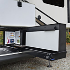This party slide is only 20” wide, and tucks nicely into most fifth wheel front storage
compartment(s). It packs a whopping punch with a 50” hidden TV on a double lift, a fold-up
countertop with hidden storage, a 110V mini refrigerator and a Suburban gas griddle on a
steel slide out tray. May Show Optional Features. Features and Options Subject to Change Without Notice.