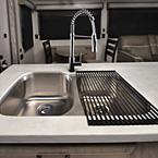 Clean up is quick and easy with stainless
steel undermount sinks and this single handle, pull-out faucet with sprayer. May Show Optional Features. Features and Options Subject to Change Without Notice.