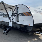 Front entry side exterior photo of the 282QBXL with the Power Awning extended. May Show Optional Features. Features and Options Subject to Change Without Notice.