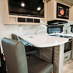 Countertop with Free-Standing Bar Seats and Television May Show Optional Features. Features and Options Subject to Change Without Notice.