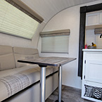Rear Lounge with Table May Show Optional Features. Features and Options Subject to Change Without Notice.
