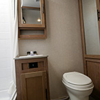Bathroom toilet and mirrored linen storage May Show Optional Features. Features and Options Subject to Change Without Notice.