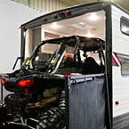 Four seat side-by-side being loaded into the garage

 May Show Optional Features. Features and Options Subject to Change Without Notice.