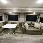 U-Shaped Dinette Next to Sofa with Two Decorative Pillows.
 May Show Optional Features. Features and Options Subject to Change Without Notice.