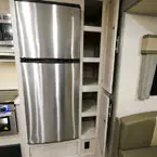 Stainless Steel Refrigerator Next to Two Door Pantry Shown Open. Five Shelves in Pantry. 
 May Show Optional Features. Features and Options Subject to Change Without Notice.