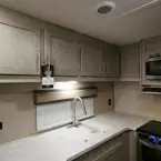 Five Cabinet Doors Shown Overhead of Kitchen Sink and Counter Top. 
 May Show Optional Features. Features and Options Subject to Change Without Notice.