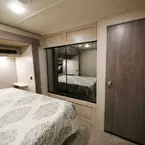 Two Door Mirrored Closet Beside Bed, Next to Full Size Closet Door.
 May Show Optional Features. Features and Options Subject to Change Without Notice.