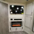 Three Door Entertainment Center with TV Mounted Above Fireplace.
 May Show Optional Features. Features and Options Subject to Change Without Notice.