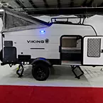 Camp Side with Tent Extended, Bike Door Shown Open to Camper.
 May Show Optional Features. Features and Options Subject to Change Without Notice.