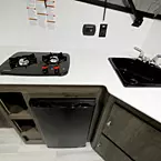 Two Burner Cook Top Next to Single Bowl Sink with Stainless Steel Faucet.
 May Show Optional Features. Features and Options Subject to Change Without Notice.