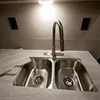 Pull Down Stainless Steel Faucet Over Double Bowl Stainless Steel Sink with Sink Covers Shown Next to Sink.
 May Show Optional Features. Features and Options Subject to Change Without Notice.