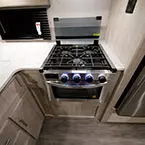 Glass Cover on Stove Shown Open to Show Three Burner Cook Top.
 May Show Optional Features. Features and Options Subject to Change Without Notice.