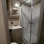 Bathroom; Mirrored Medicine Cabinet Overhead of Single Bowl Vanity, Angled Shower with Glass Doors.
 May Show Optional Features. Features and Options Subject to Change Without Notice.