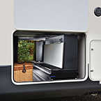 OUTDOOR PARTY CENTER
This party slide is only 20” wide, and tucks nicely into most fifth wheel front storage compartment(s).
It packs a whopping punch with a 50” hidden TV on a double lift, a fold-up countertop with hidden storage, a 110V mini refrigerator and a Suburban gas griddle on a steel slide out tray. May Show Optional Features. Features and Options Subject to Change Without Notice.