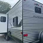Exterior Aurora 29QBS rear with slide out open and outside shower, Spare Tire, Carrier, and Cover
 May Show Optional Features. Features and Options Subject to Change Without Notice.