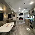 full view of back to front of coach, living area, kitchen area and entry door and door to bedroom shown closed
 May Show Optional Features. Features and Options Subject to Change Without Notice.