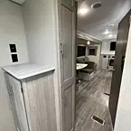 bunk room cabinet with tv hookup option, hallway cabinets and partial view from back to front of coach
 May Show Optional Features. Features and Options Subject to Change Without Notice.