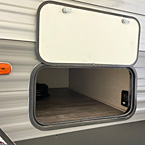 Close-up of exterior off-door side storage space with panel door open
 May Show Optional Features. Features and Options Subject to Change Without Notice.