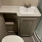 Bathroom sink with cabinet storage an marine toilet with foot flush
 May Show Optional Features. Features and Options Subject to Change Without Notice.