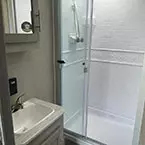 Bathroom with sink, mirrored medicine cabinet and shower with glass sliding door May Show Optional Features. Features and Options Subject to Change Without Notice.