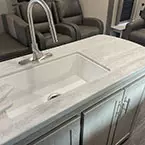 Island with kitchen sink under-mounted farm style basin and counter covers off May Show Optional Features. Features and Options Subject to Change Without Notice.