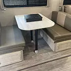 Kitchen dinette with pedestal thermofoil table, underbench storage with easy access doors to storage  May Show Optional Features. Features and Options Subject to Change Without Notice.