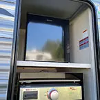 Close up of camper kitchen with pull-out griddle and mini refrigerator May Show Optional Features. Features and Options Subject to Change Without Notice.