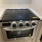 Close up of 3 burner SST range with flush glass top May Show Optional Features. Features and Options Subject to Change Without Notice.