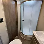 Bathroom with marine toilet with foot flush, shower and sink  May Show Optional Features. Features and Options Subject to Change Without Notice.