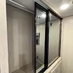 Mirrored wardrobe with sliding door shown open May Show Optional Features. Features and Options Subject to Change Without Notice.
