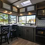 Rear Kitchen with Bar and Barstools May Show Optional Features. Features and Options Subject to Change Without Notice.