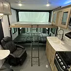 View of roll-over sofas shown open with queen bed electric lift shown down with ladder May Show Optional Features. Features and Options Subject to Change Without Notice.