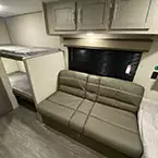 Jiffy sofa with flip down arm rest/cup holder, kickboard storage underneath and overhead storage cabinets May Show Optional Features. Features and Options Subject to Change Without Notice.