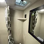 Bathroom mirror with shower to the left and vent fan in ceiling May Show Optional Features. Features and Options Subject to Change Without Notice.