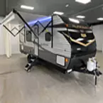 Front quarter view of Aurora 26BH with awning shown extended May Show Optional Features. Features and Options Subject to Change Without Notice.