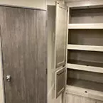Wardrobe/pantry cabinet with doors shown open May Show Optional Features. Features and Options Subject to Change Without Notice.