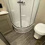 Bathroom with toilet with foot flush, shower with sliding glass door and sink May Show Optional Features. Features and Options Subject to Change Without Notice.