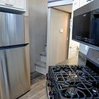 3 burner range with overhead microwave and stainless-steel refrigerator May Show Optional Features. Features and Options Subject to Change Without Notice.