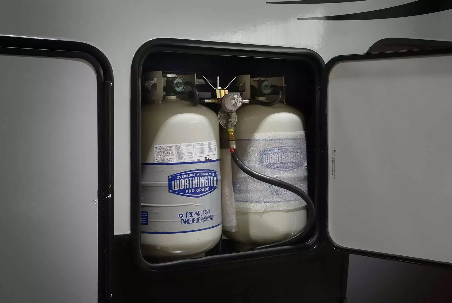 Gray and blue propane tanks in a Forest River RV